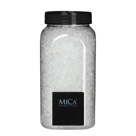 Gjennomsiktige glasssteiner fra Mica Decorations i en beholder med sort lokk til dekorasjoner og vinterlandskap